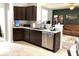 Kitchen with granite countertops, dark wood cabinets, and stainless steel appliances at 5702 Deer Valley Ct, Columbus, IN 47201