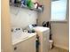 Laundry room features white washer and dryer with shelving for storage at 5702 Deer Valley Ct, Columbus, IN 47201