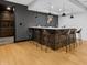 Basement bar features a wooden bar with seating, countertops, and view of the wine cellar at 5946 Stafford Way, Indianapolis, IN 46228
