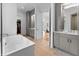 Luxurious bathroom with a soaking tub, vanity, and access to a walk-in closet at 5946 Stafford Way, Indianapolis, IN 46228