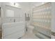 Clean bathroom featuring modern vanity, toilet, and a shower with a patterned curtain at 5946 Stafford Way, Indianapolis, IN 46228