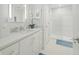 Bright bathroom features white cabinets, marble countertop, glass enclosed shower and hex tile flooring at 5946 Stafford Way, Indianapolis, IN 46228