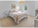 Comfortable bedroom with neutral decor, a quilt-covered bed, and a bedside table at 5946 Stafford Way, Indianapolis, IN 46228