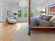 Cozy bedroom with a four-poster bed, neutral tones, and a view of the outdoors at 5946 Stafford Way, Indianapolis, IN 46228