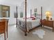 Elegant bedroom with four-poster bed, ornate details, and natural light from large windows at 5946 Stafford Way, Indianapolis, IN 46228