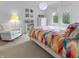 Bright bedroom with a colorful bedspread, rocking chair, and plenty of natural light at 5946 Stafford Way, Indianapolis, IN 46228