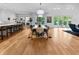 Open-concept dining room with modern lighting, hardwood floors, and access to the backyard pool at 5946 Stafford Way, Indianapolis, IN 46228