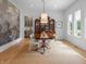 Elegant dining room featuring a decorative wall covering, natural lighting, and modern chairs at 5946 Stafford Way, Indianapolis, IN 46228
