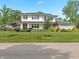 Beautiful two-story house featuring lush landscaping, a green lawn and classic design at 5946 Stafford Way, Indianapolis, IN 46228