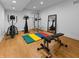 Home gym featuring gym equipment, an exercise mat, hardwood floors and mirrors at 5946 Stafford Way, Indianapolis, IN 46228
