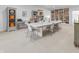 Spacious living room featuring a large table, built-in bookshelves, and stylish decor at 5946 Stafford Way, Indianapolis, IN 46228