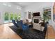 Bright living room with a fireplace, built-in shelves, and access to the pool area at 5946 Stafford Way, Indianapolis, IN 46228