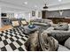 Finished basement living room area with grey sofas, black and white rug, and a partial view of the bar at 5946 Stafford Way, Indianapolis, IN 46228