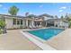 Backyard featuring a rectangular pool with lounge chairs and a covered outdoor kitchen and seating area at 5946 Stafford Way, Indianapolis, IN 46228