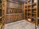 Wine cellar featuring custom wooden shelving and storage for wine bottles with tiled floor at 5946 Stafford Way, Indianapolis, IN 46228
