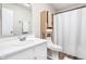 Bathroom features white vanity, toilet, and shower with convenient built-in storage at 5966 Draycott Dr, Indianapolis, IN 46236