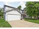 Charming two-story home with a two-car garage, tidy landscaping, and inviting front porch at 5966 Draycott Dr, Indianapolis, IN 46236