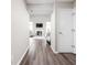 Open-concept hallway showcasing the view of the living room with a fireplace and natural light at 5966 Draycott Dr, Indianapolis, IN 46236