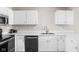 Bright kitchen with white cabinets, stainless steel sink, and quartz countertops at 5966 Draycott Dr, Indianapolis, IN 46236