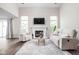 Bright living room featuring a fireplace, large windows, and comfortable seating at 5966 Draycott Dr, Indianapolis, IN 46236