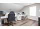 Home office with white desks, rolling chairs, and hardwood floors at 5966 Draycott Dr, Indianapolis, IN 46236