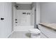 This bathroom has a shower and bathtub combination with neutral colored walls and tile floors at 603 Daviess Dr, Westfield, IN 46074