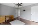 This bedroom has a ceiling fan, wood floors, a TV mount, and neutral colored walls at 603 Daviess Dr, Westfield, IN 46074