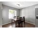 Dining area featuring a wood table, four chairs, hardwood flooring, and a bright window view at 603 Daviess Dr, Westfield, IN 46074