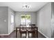 Bright dining area with a wood table, chairs, natural light from the window and hardwood floors at 603 Daviess Dr, Westfield, IN 46074