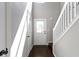 Bright foyer with hardwood floors, stairs and a white door at 603 Daviess Dr, Westfield, IN 46074