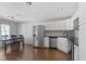 Bright kitchen and dining area featuring modern appliances, white cabinets, and hardwood flooring at 603 Daviess Dr, Westfield, IN 46074