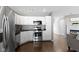 A modern kitchen with stainless steel appliances next to a stairway and cozy living area at 603 Daviess Dr, Westfield, IN 46074