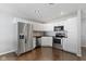 Well-equipped kitchen with stainless steel appliances, white cabinetry, and dark countertops at 603 Daviess Dr, Westfield, IN 46074