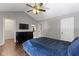 The main bedroom features a ceiling fan, a large dresser, and a TV on the wall at 603 Daviess Dr, Westfield, IN 46074