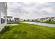 Beautiful backyard view of community pond and homes with inviting green space at 6114 Pebblebrooke Rd, Whitestown, IN 46075