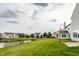 Community backyard with a pond, green space, and neighborhood homes at 6114 Pebblebrooke Rd, Whitestown, IN 46075