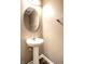 Bathroom with pedestal sink and updated lighting at 6114 Pebblebrooke Rd, Whitestown, IN 46075