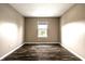 Neutral-toned bedroom with wood floors, a window, and ample natural light at 6114 Pebblebrooke Rd, Whitestown, IN 46075