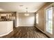 Dining area with exterior access, natural light, pendant lighting, and wood-look flooring at 6114 Pebblebrooke Rd, Whitestown, IN 46075