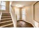 Inviting entryway featuring wood floors, a decorative glass door, and a staircase leading to the upper level at 6114 Pebblebrooke Rd, Whitestown, IN 46075