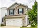 Attractive two-story home featuring stone accents and a white two-car garage at 6114 Pebblebrooke Rd, Whitestown, IN 46075