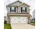 Beautiful two-story home with stone accents and a white two-car garage at 6114 Pebblebrooke Rd, Whitestown, IN 46075