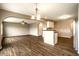 Open-concept living room features modern lighting, ceiling fan, and wood-look flooring at 6114 Pebblebrooke Rd, Whitestown, IN 46075