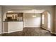 Open-concept living room with abundant natural light, pendant lighting, and wood-look flooring at 6114 Pebblebrooke Rd, Whitestown, IN 46075