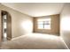 Bright living room with neutral carpet, fresh paint, and natural light from a large window at 6114 Pebblebrooke Rd, Whitestown, IN 46075