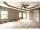 Spacious main bedroom featuring tray ceilings, carpeted floors and natural light from windows at 6114 Pebblebrooke Rd, Whitestown, IN 46075