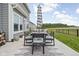 Outdoor patio area with stylish furniture and a view of the green space and treeline at 6305 N Woodhaven Dr, McCordsville, IN 46055