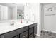 Bathroom featuring double sinks, dark cabinets, and a shower with glass doors at 6305 N Woodhaven Dr, McCordsville, IN 46055