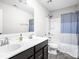 Bathroom featuring double sinks, dark cabinets, and shower with a blue curtain at 6305 N Woodhaven Dr, McCordsville, IN 46055