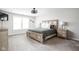 Bright bedroom with a large window, carpet flooring and wooden furniture at 6305 N Woodhaven Dr, McCordsville, IN 46055